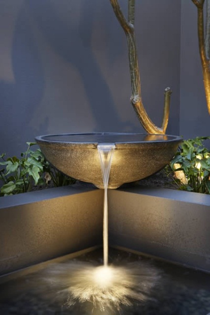 Stone bowls are perfect for modern backyard waterfalls.