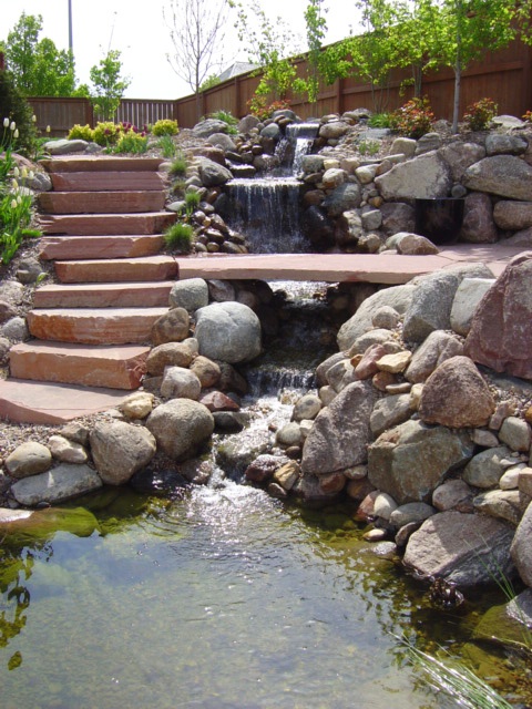 If your backyard is located on sloping slope then it's really logical to build a waterfall there.