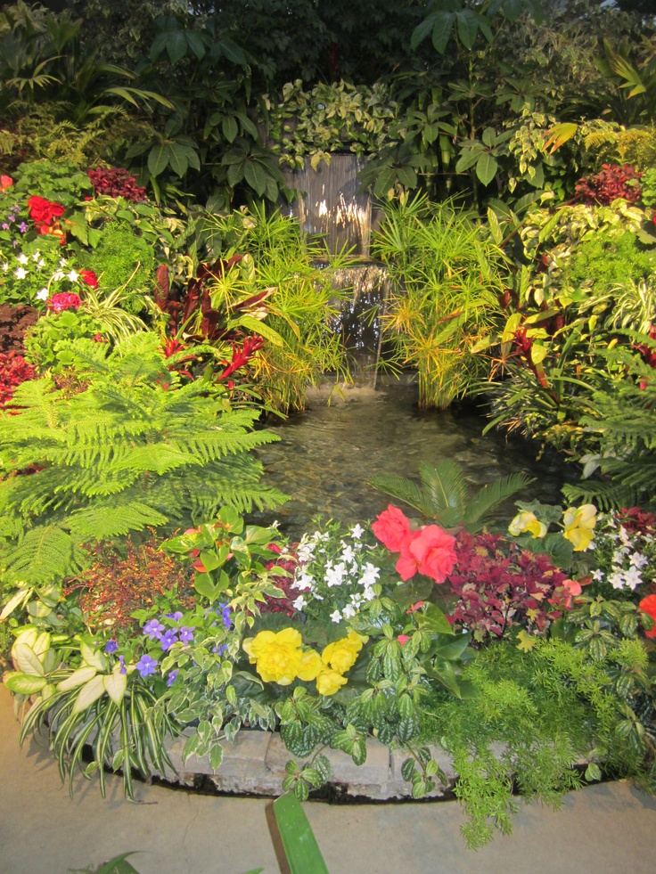 Surround your garden waterfall with flowers and it'd look like it was there before your house.