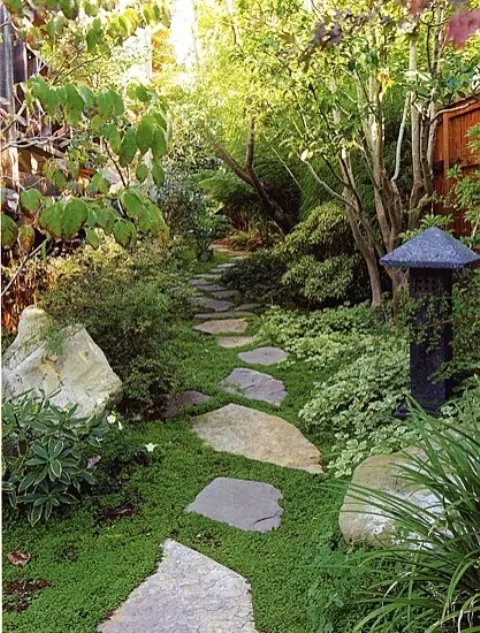 green grass, mini shrubs, trees and a tone lantern in Japanese style will make the front yard look very zen-like