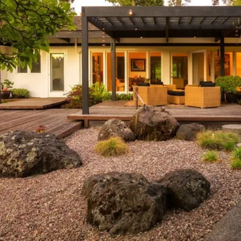 pebbles with large rocks covered with moss and a bamboo fountain will make the front yard look very cool and very Asian-like