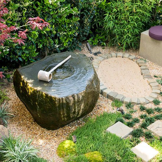 grass, pebbles, bricks and a stone fountain bowl with a wooden scoop for a casual and relaxed Japanese feel in the garden