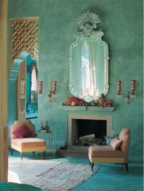 a bold aqua living room with wall lamps and a mirror in a unique frame for a Moroccan feel