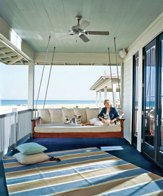 a hanging upholstered bench on chains is a cool idea for a nautical porch, you can enjoy the views here