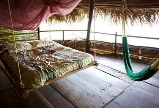 a hanging bamboo bed on ropes is ideal for a tropical outdoor space, it perfectly highlights the esthetics of the space