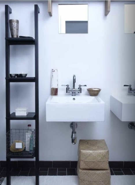 a black and white bathroom with two sinks, a large open storage unit and boxes for storage
