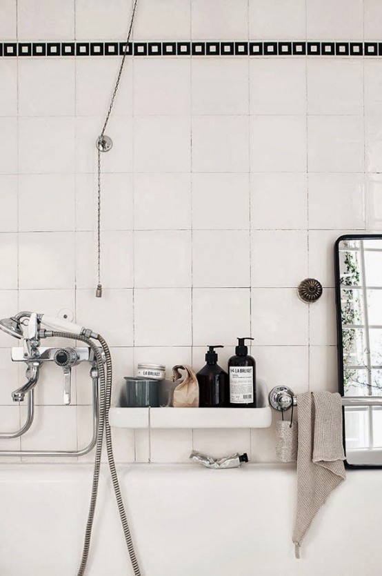 an off-white Scandinavian bathroom can be accented with black and vitnage appliances and faucets
