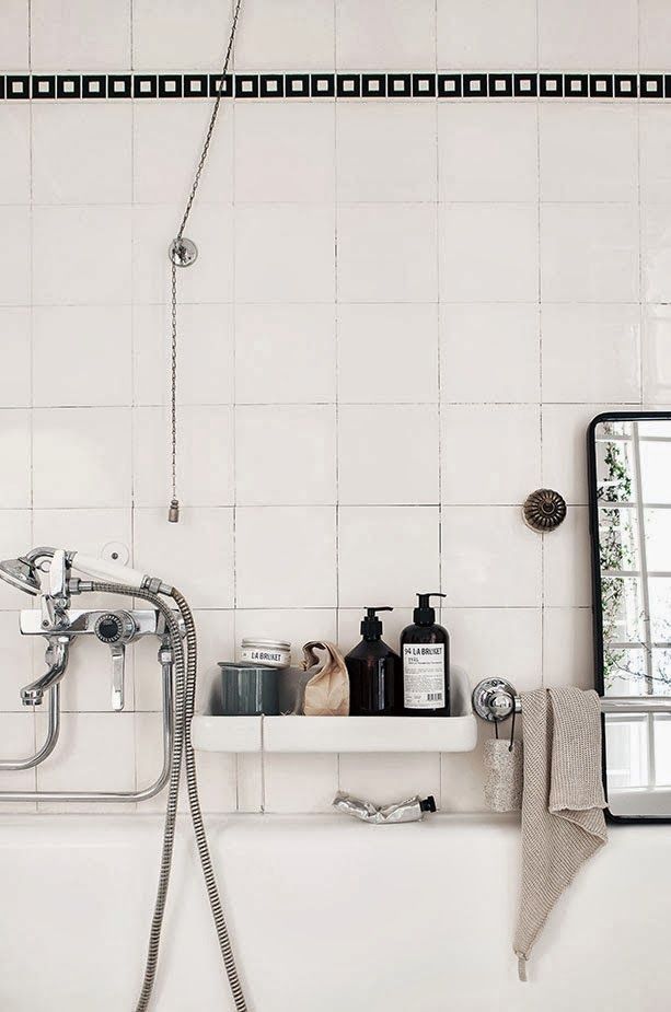 An off white Scandinavian bathroom can be accented with black and vitnage appliances and faucets