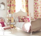a bright vintage bedroom with refined neutral furniture, floral and bright pink textiles, a chic mirror and a mirrored nightstand is amazing