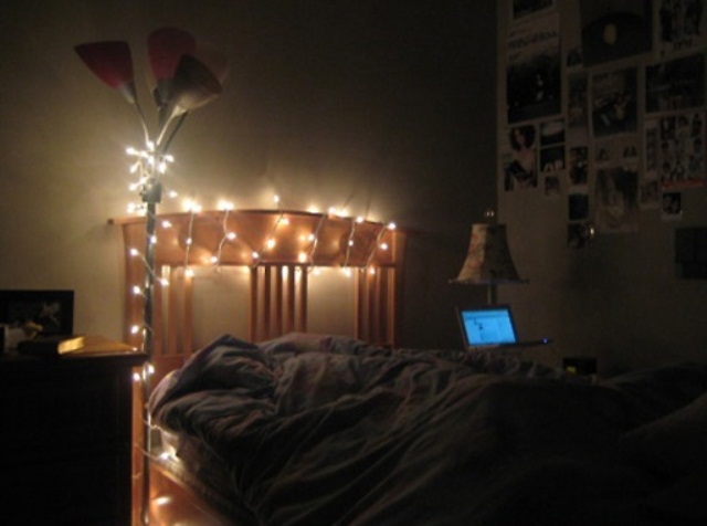 The headboard covered with lights and a floor lamp with lights
