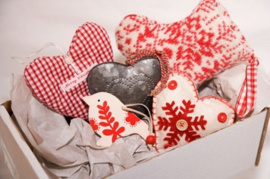 a box with red and white fabric heart Christmas ornaments done in vintage style is a very chic idea
