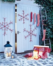 red and white Christmas decor – large snowflakes, stockings and gift boxes plus candle lanterns for a Scandinavian feel