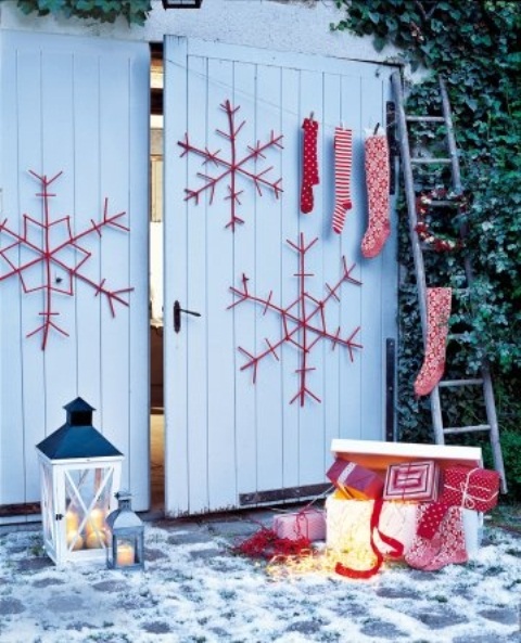 Red and white Christmas decor   large snowflakes, stockings and gift boxes plus candle lanterns for a Scandinavian feel