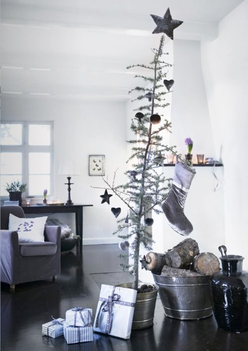 a Christmas tree in a bucket, wooden ornaments and firewood in galvanized buckets for a cozy Nordic feel