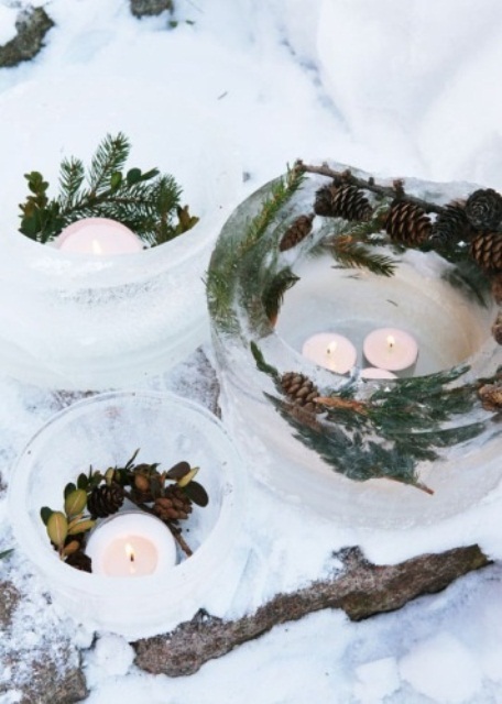 ice bowls with evergreens and pinecones and candles in them for Nordic outdoor decor