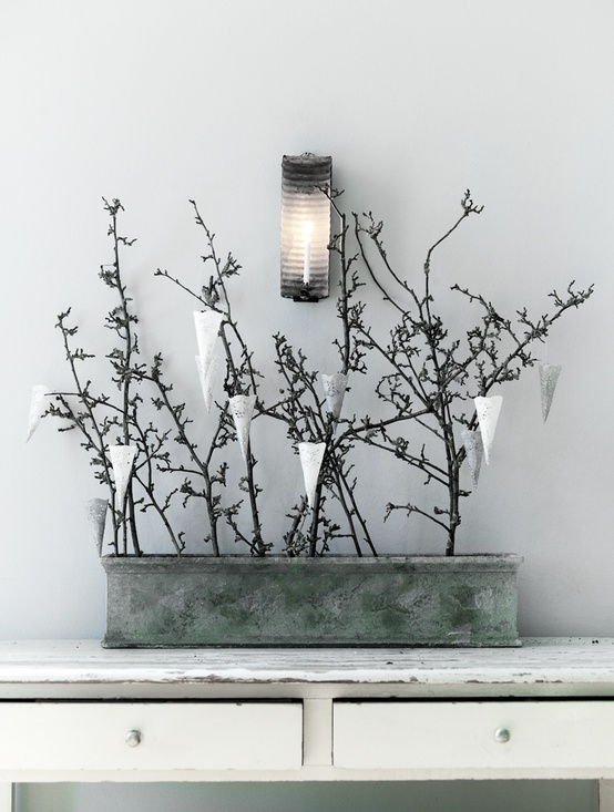 a tin can with branches and white and silver paper cones is a stylish Nordic decoration with a natural feel