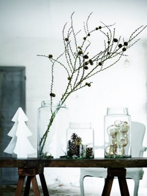 Three big glass jars   with pinecones, metallic ornaments and branches with pinecones for a modern Nordic feel
