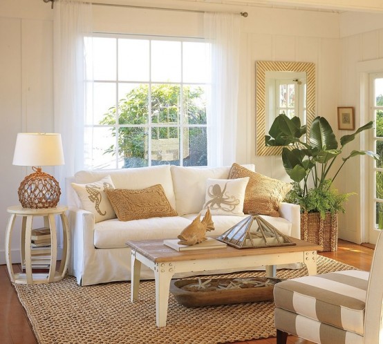 a neutral coastal living room with plenty of texture - rattan, jute, wood, starfish in a dough bowl and potted plants