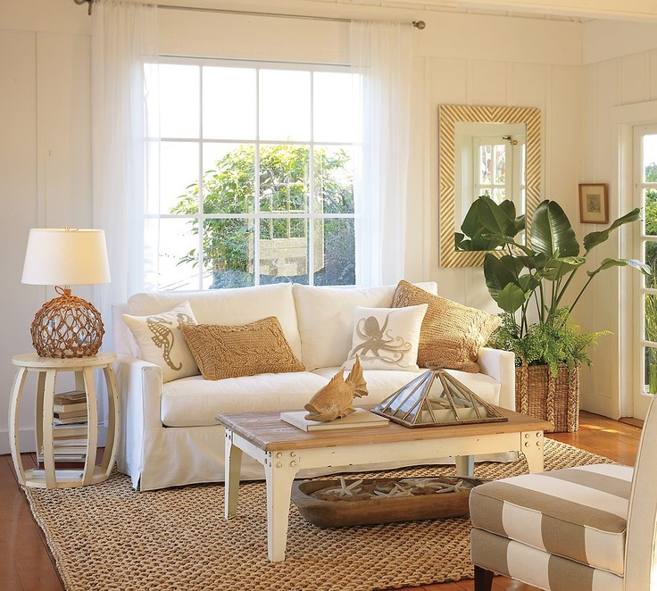 A neutral coastal living room with plenty of texture   rattan, jute, wood, starfish in a dough bowl and potted plants