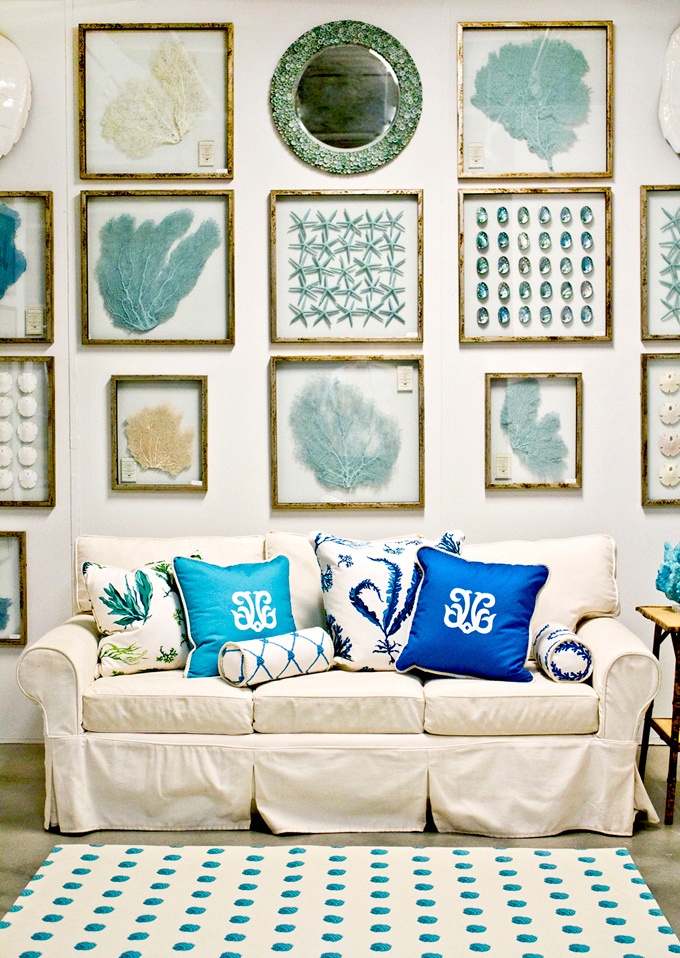 A neutral sofa and a bold gallery wall inspired by sea and sea creatures for a beach living room
