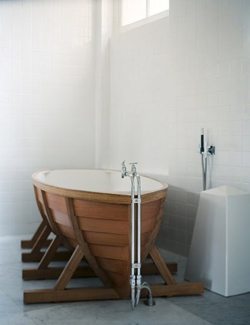 a contemporary bathroom in neutrals with a boat-shaped bathtub will increase the ocean-inspired feel in the space