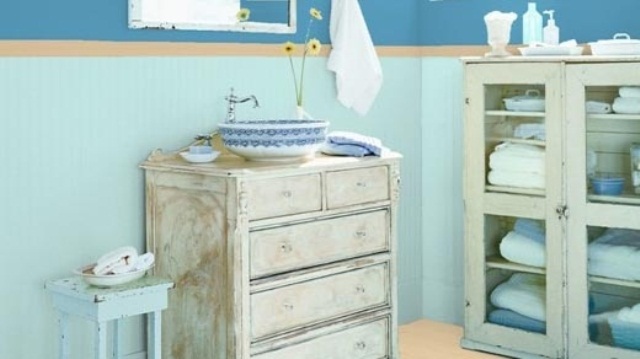 bold blue and aqua bathroom with shabby chic furniture, a beautiful porcelain vessel sink