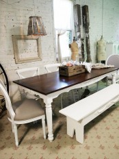 a shabby chic meets rustic dining room with a vintage rustic dining set, with a white bench, a vintage chandelier and lamps