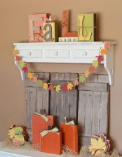a colorful paper leaf garland or banner is a stylish idea for fall and Thanksgiving and it can be easily DIYed