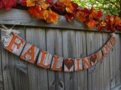 a creative wooden banner with letters and hearts painted on the wood is a cool and chic fall and Thanksgiving decor idea with a rustic feel