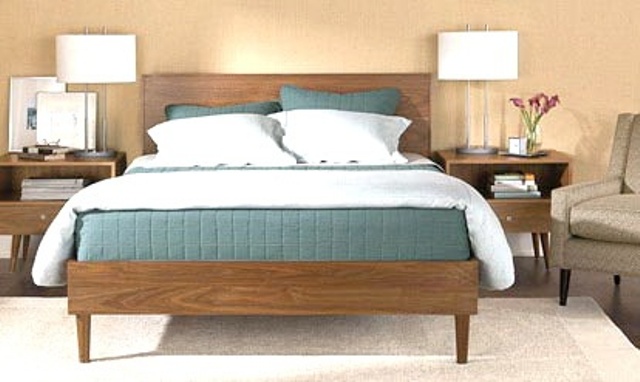 A warm stained wooden bed and nightstands will be a nice base for a mid century modern space