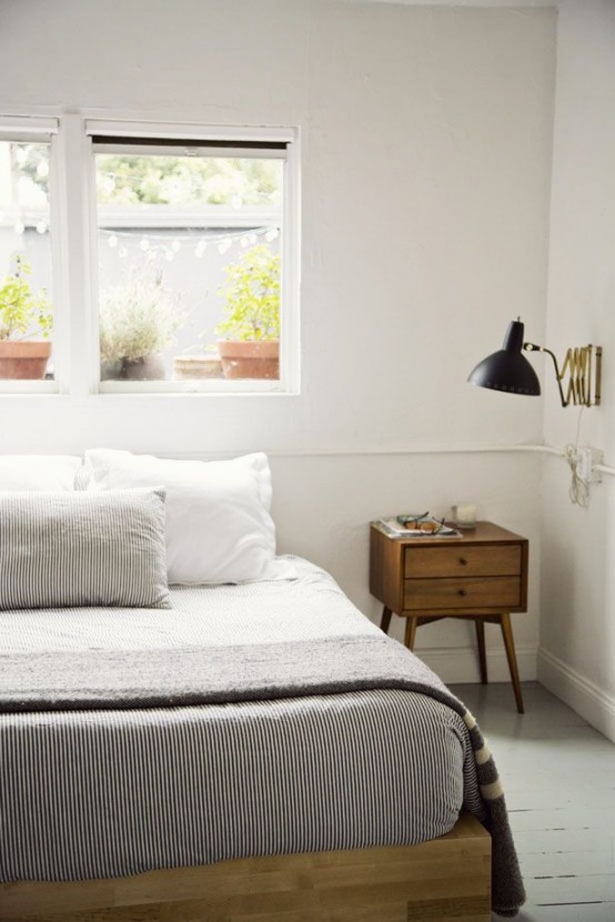 a simple and laconic light-stained wooden bed for a stylish neutral mid-century modern bedroom