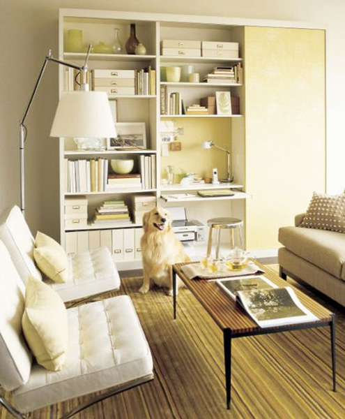 Several bookcases could become your tiny yet functional home office right in the living room. A small desk combined with open and closed storage space are really versatile.