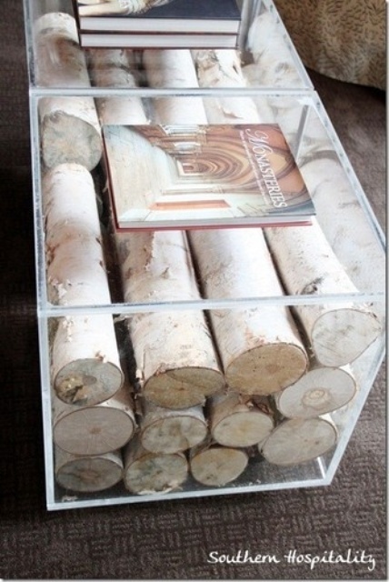 In case you don't want to use a tiered coffee table to store such things as books and magazines here is a nice decor idea for you. Put some wood logs in it. Even if there is no fireplace in your living room and you don't need to store firewood such table would add a cozy touch to the room's decor.
