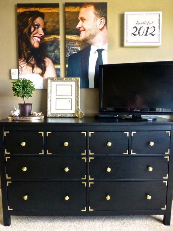 Changing knobs and adding some metal decor turn a plain black dresser into a stylish storage solution for a living room.