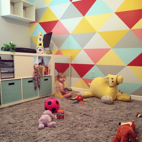 Small And Bold Kids Playroom With A Bold Geo Wall