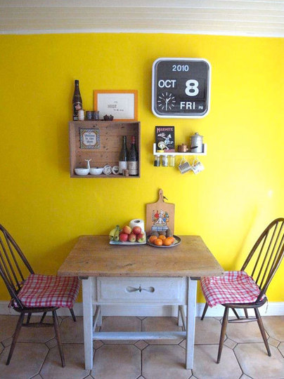 Small And Cozy Dining Area With Yellow Wall