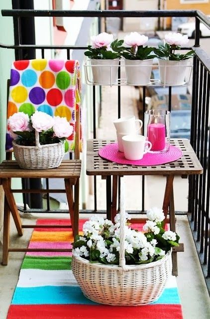 Brighten up your balcony colorful rugs and accessories like here   a bold rug, placemat and a pillow
