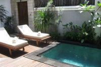 small plunge outdoor pool with a wooden deck