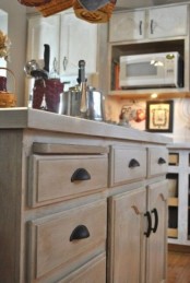 a whitewashed cabinet for a modern or farmhouse kitchen is a lovely idea – just whitewash your own stained cabinet and voila