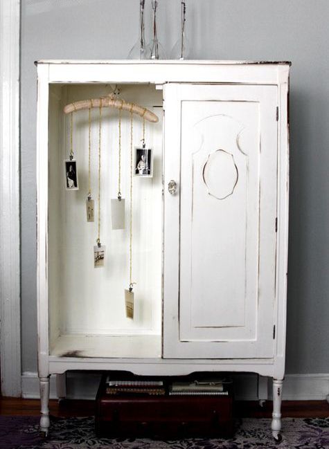 a vintage whitewashed storage unit with a door and an open storage compartment with decor is a very cool and lovely idea