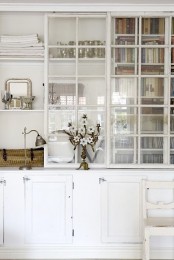 an oversized whitewashed storage cabinet with glass sliding doors and closed storage cabinet is a lovely idea for any space