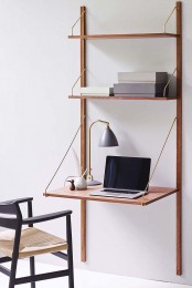a wall -mounted shelving unit with a foldable desk is a nice option for a small space