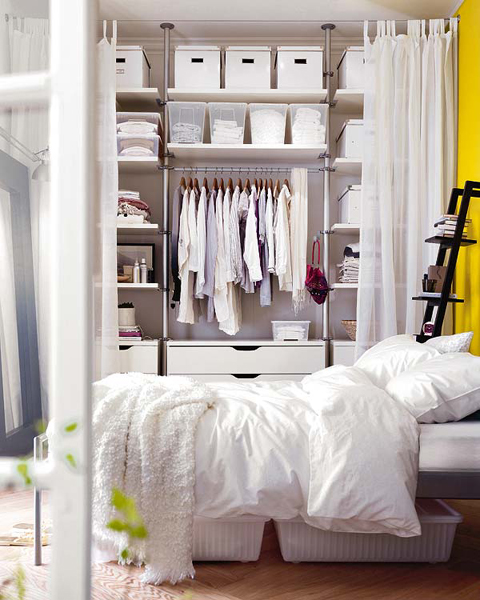 IKEA storage units allow you to create fully functional wardrobe that occupy any space you want. Just cover it with a curtain and it would be easy to access.