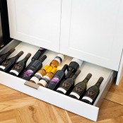 a low drawer under the cabinets can be used for storing wine bottles if they don’t require any special temperature