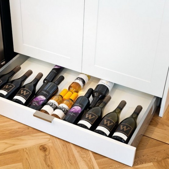 a low drawer under the cabinets can be used for storing wine bottles if they don't require any special temperature