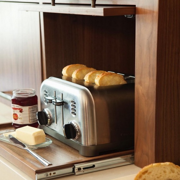 A toaster hidden inside a cabinet and placed on a retractable shelf is a cool idea for any home, hide it and make the space sleek