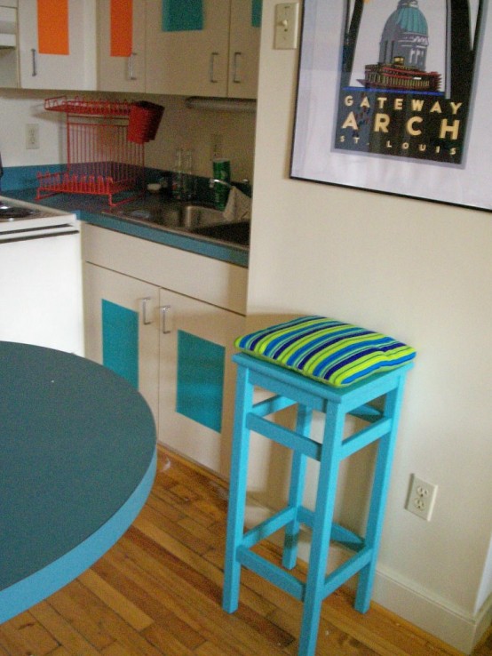 an IKEA Oddvar stool with added height, painted turquoise and with bright upholstery