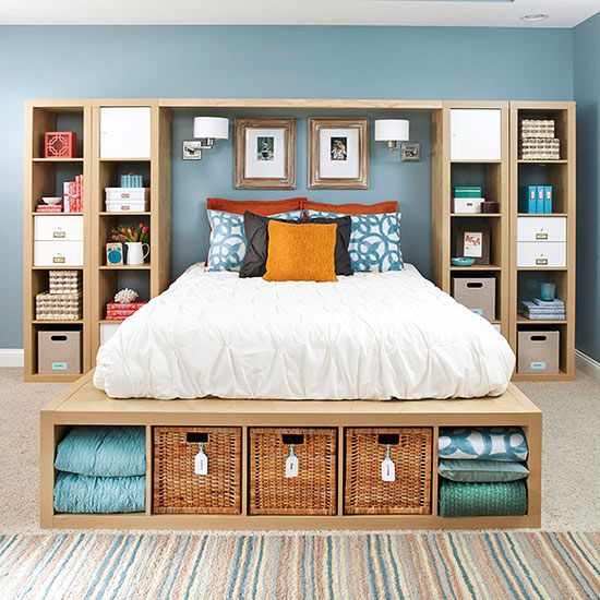 A sleek wooden bed with storage compartments at the foot   finish soem of them with woven boxes for a slight rustic feel