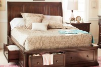 a dark stained bed with lots of drawers with knobs is a perfect piece to rock in your space