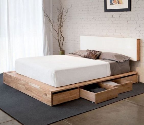 a sleek minimalist bed with invisible side drawers is a smart solution for a small space